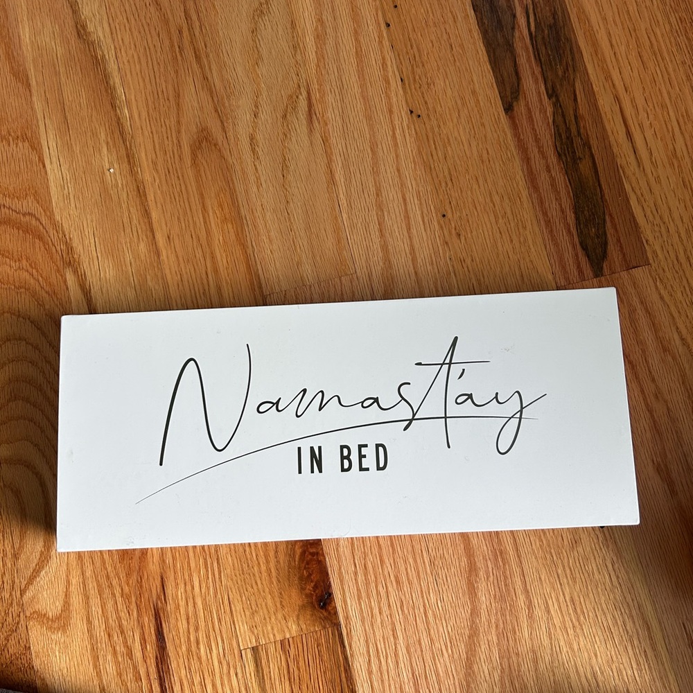 White 'Namastay in Bed' Sign